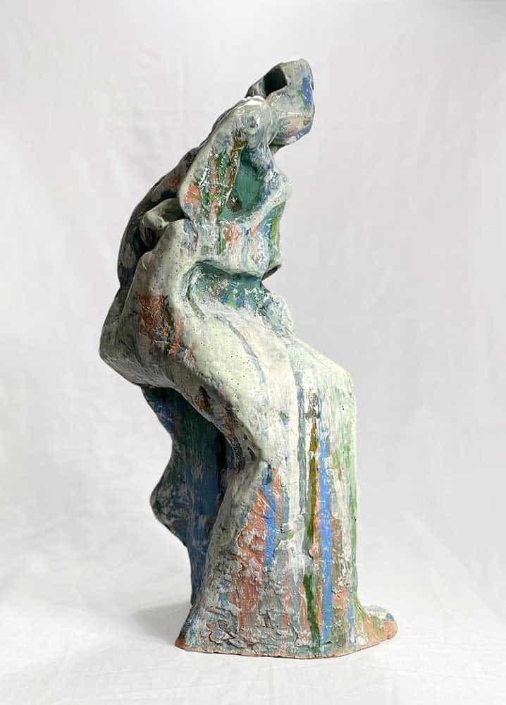 Abstract figurative ceramic sculpture with green, blue and white glaze on fired terracotta