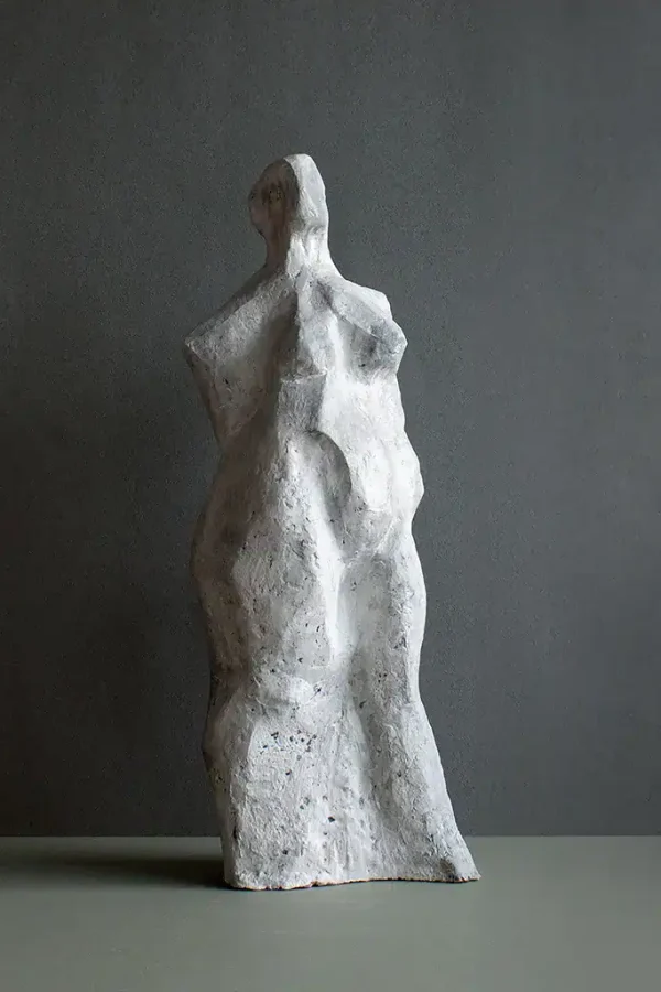 Contemporary ceramic sculpture of a female form, textured white finish, art piece by Ellen Scobie.